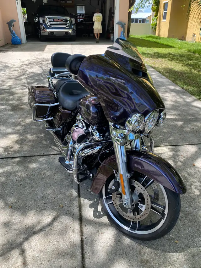 Purple-black Harley-Davidson touring bike on a driveway